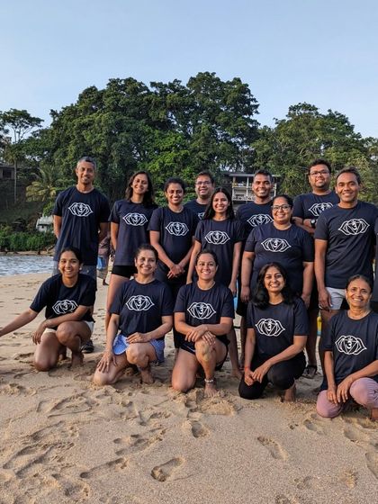 The Aayana retreat family, gathered on the sand at dusk. We even made a new friend who decided to join our group photo.