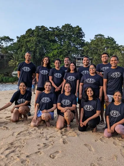 The Aayana retreat family, gathered on the sand at dusk. We even made a new friend who decided to join our group photo.