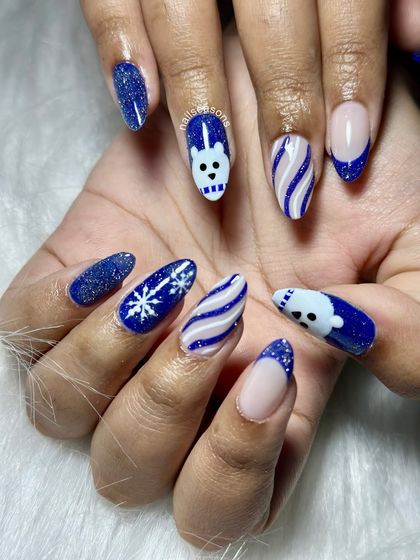 A fun and playful Christmas set. This design features glittery blue polish, candy cane stripes, snowflakes, and a cute hand-painted polar bear.
