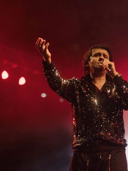 A candid moment of Sonu Nigam performing under red stage lights. My goal here was to capture the raw emotion and power in his voice through his expressive gestures.