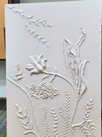 This all-white sample board showcases a variety of botanical forms and textures. It allows the client to focus purely on the sculptural elements of the design without the influence of color.