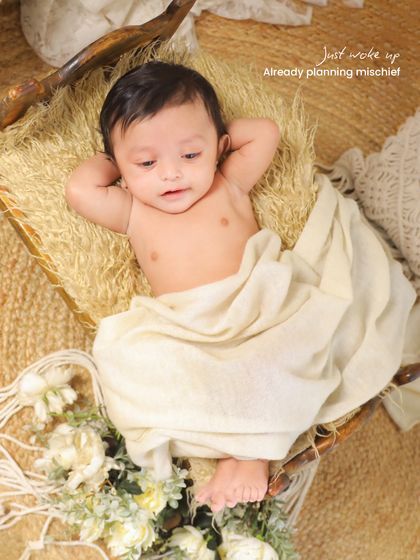 Just woken up and taking in the world. This candid shot captures a beautiful, natural moment in a rustic, boho-themed setup with macrame and natural fibers.