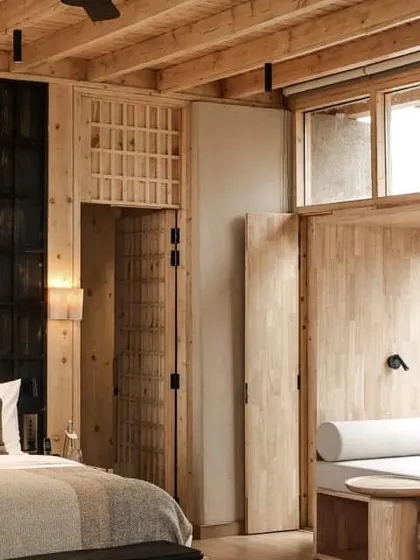 The hotel's interiors are a warm and cozy retreat, with wood-paneled walls and curated textiles providing comfort against the rugged landscape.