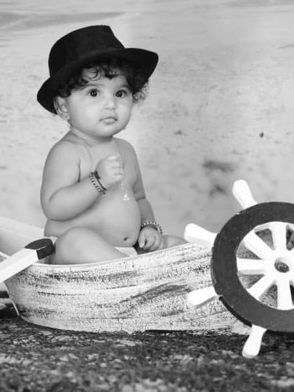 Explore our full nautical and beach-themed collection. These images showcase the variety of poses and angles possible with our boat prop, sand-colored flooring, and ocean backdrop.