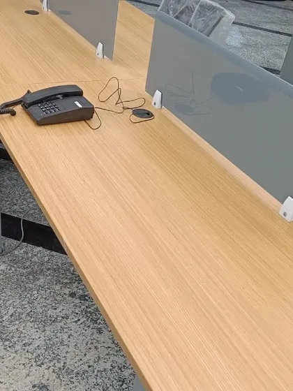 A wide view of an office workspace with intercom phones set up at each station, ready for employees to use.