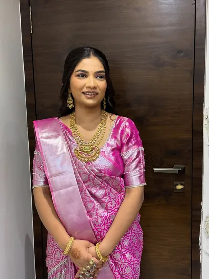 The final portrait from our "lotus statement" shoot. The makeup is soft and glowing, perfectly matching the delicate pink of the saree and the floral hair accessory.