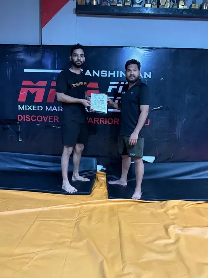 Presenting a certificate of participation to one of our dedicated athletes after the successful completion of our training camp.