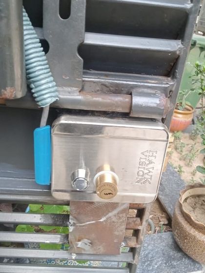 A duplicate image of the installed Hawkvision electronic lock, showing how it fits securely onto the client's main gate.