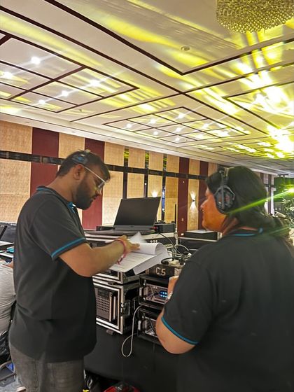 Our team reviewing the show flow at the 'Coolie' music launch. We are always prepared and synchronized.