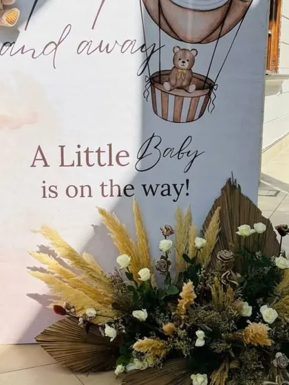 A detailed shot of the "A Little Baby is on the way!" backdrop, with transparent baby blocks filled with teddy bears.