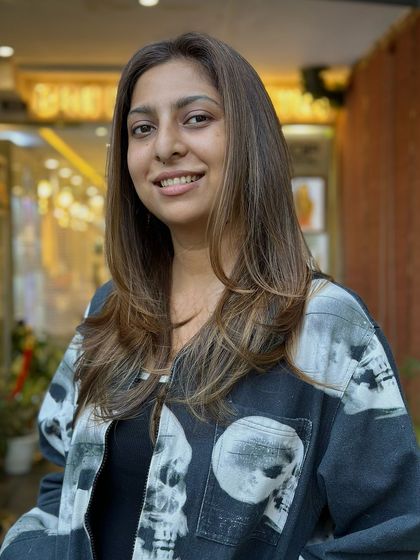A close-up of the client's smile, reflecting her happiness with the beautiful balayage and new look.