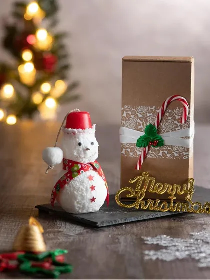 This little snowman candle is all dressed up for the holidays! He's ready to be gifted in a box decorated with a candy cane.