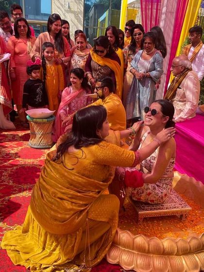 A candid moment from a fun-filled Haldi ceremony. I help style the entire event, ensuring the bride, groom, and family have coordinated and comfortable outfits.