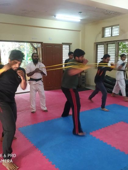 Group training with resistance bands. This drill builds explosive power in our punches. We train together, we grow stronger together.