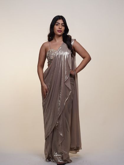 Another look at the metallic pre-draped saree, showing its full silhouette. The liquid-metal fabric drapes beautifully and catches the light with every move.