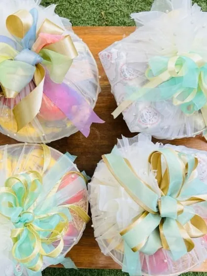 My full-service trousseau packing focuses on the details. Here, I've used delicate net wrapping with multi-colored pastel and gold ribbons to bundle gifts, creating an elegant and cohesive look for the gift exchange ceremony.