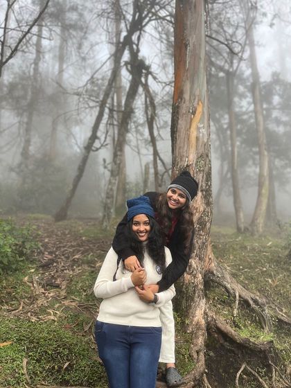 A couple enjoying a moment in the misty forest.
