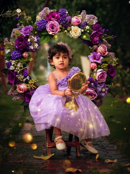 We can create pure magic together. This enchanted forest theme with a floral wreath and sparkling fairy lights turned this toddler's portrait into a real-life fairytale.