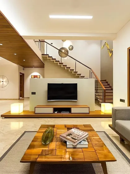 In this open-plan living area, we used a low-profile TV console to maintain an airy feel, with the staircase creating a dramatic visual backdrop. The space is designed for flow and connection, perfect for modern family living.