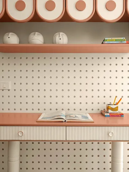 Details are where a room finds its soul. This close-up shows a custom-designed study desk with fluted drawer details, set against a versatile pegboard wall, demonstrating how practical elements can be elevated with thoughtful craftsmanship.