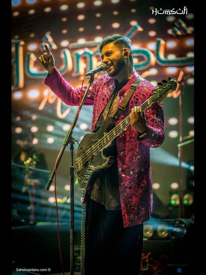 Our bassist, in a striking pink jacket, owning the stage with his performance.