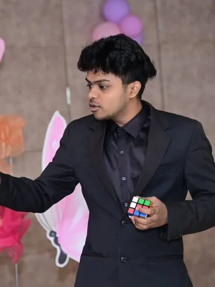 Focus and misdirection are key. Here's a moment from a stage show where I'm performing Rubik's cube magic. It's a trick that requires intense concentration and always leaves the audience wondering, "How did he do that?".