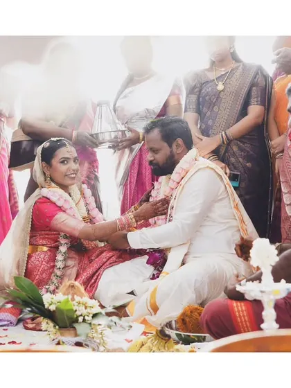 Capturing the quiet solemnity of a South Indian wedding ceremony. I focus on the meaningful details, like the exchange between the couple, surrounded by the vibrant colors of their family and traditions.