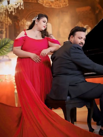 This hot pink infinity gown with a dramatic trail is designed to make you stand out. The bold color and flowing fabric create a vibrant and energetic feel for any photoshoot.