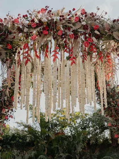 The hanging tuberose chandelier was the centerpiece of our 'Regal Rustic Reverie' mandap. This detail, inspired by high fashion and traditional Indian florals, added a touch of opulence and fragrance to the ceremony.