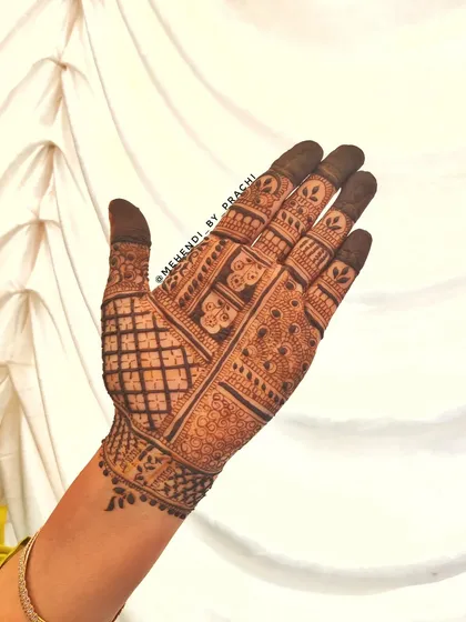 A full-coverage back-hand design with intricate Indian patterns. The mix of grids, dots, and floral elements creates a rich texture that is both traditional and visually interesting.