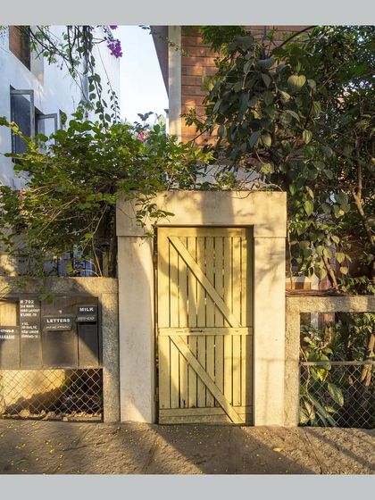 The entrance gate and letterbox detail, showing how even the most functional elements are designed with care and natural materials.