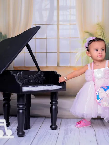 Ready for her performance. This shot includes musical note props to further enhance the theme and add a playful touch to the photograph.