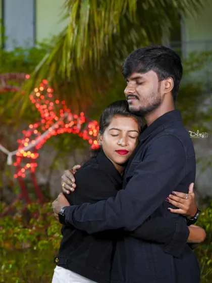 An intimate embrace with a beautifully lit red deer prop in the background. Our unique props add a special touch to your night photos.
