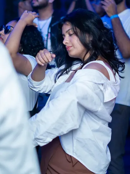 A guest dancing and enjoying the vibe at the White Party. We focus on creating an atmosphere where people can let loose and have a great time.