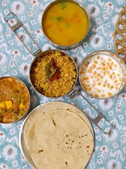 Today's special menu features tangy Puliyogre rice, creamy mutter paneer, simple dal, and cooling boondi raita. It's a delicious combination of flavors from across India.