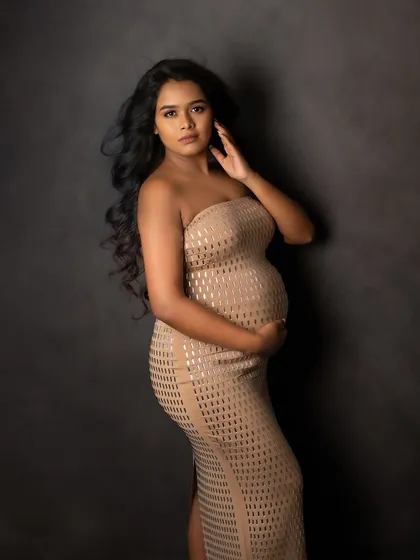 A confident and direct gaze. This portrait captures the strength and power of a woman about to become a mother.