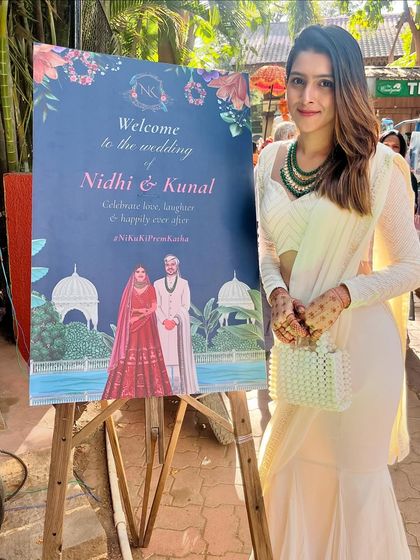 Here I am, proudly standing next to a wedding welcome board I designed. It's always amazing to see the final printed piece become a part of the couple's special day and their memorable photos.