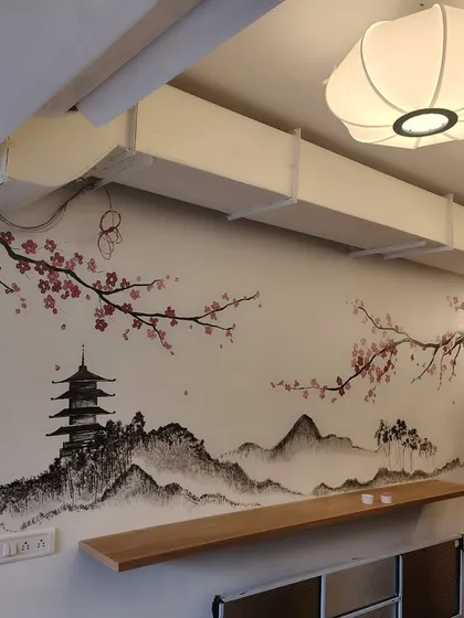 For this Japanese-themed cafe, I painted a subtle, sketch-like cherry blossom landscape. The design includes a Japanese prayer for prosperity and happiness, creating a peaceful and authentic atmosphere.