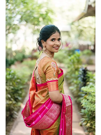 A beautiful shot of the bride looking over her shoulder with a sweet smile. The movement in her saree adds a dynamic and graceful element to the portrait.