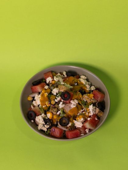 A wider shot of the Watermelon Feta Chicken Salad, showing the beautiful colors and fresh ingredients before the mango-chipotle dip is added.