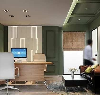 This director's office combines classic comfort with modern functionality. The design uses a soothing olive green on the paneled walls, a rich leather chesterfield sofa, and contemporary lighting to create a workspace that is both authoritative and inviting.