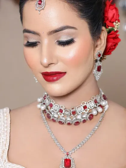 The eyes are the focus here, with a beautiful silver shimmer that opens them up. The student has perfectly balanced a bold lip with elegant eye makeup.