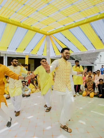 The groom and his friends put on a surprise dance performance for the bride during the Haldi ceremony.