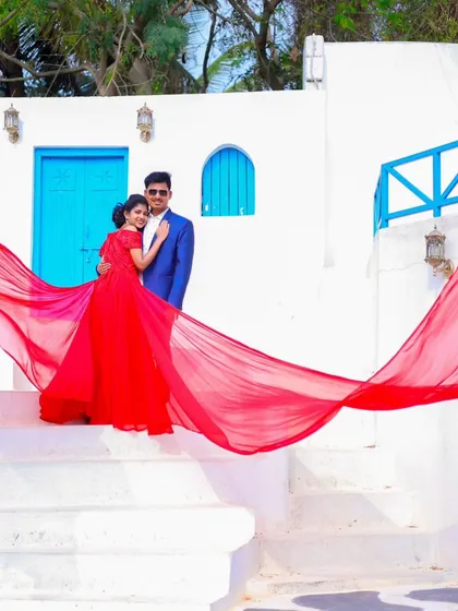 A wide shot showing the dramatic effect of a flowing red gown at our Santorini set. This is how we create magazine-worthy pre-wedding photos.