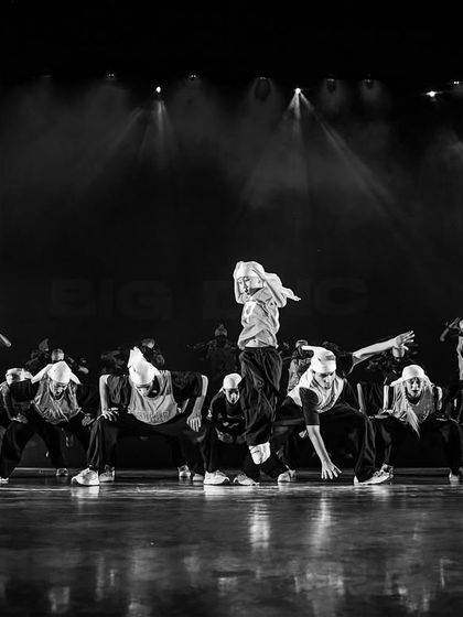 A black and white shot capturing the raw energy of a hip-hop showcase. Our performances are dynamic, artistic, and always unforgettable.