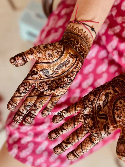 An intricate design filled with graceful birds and lotus flowers, creating a flowing, nature-inspired pattern on the palms.