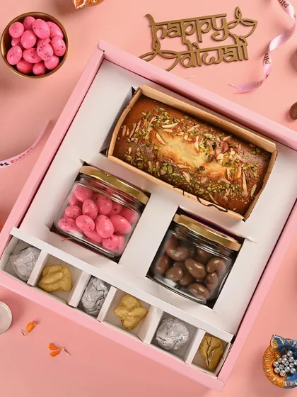 This is my "Shahi" Diwali hamper, a perfect example of what we do. It features our in-house, eggless Mawa Cake, Pink Almond Dragees, Chocolate Coated Cashews, and assorted nut rocks, all packed beautifully in our signature pink box.