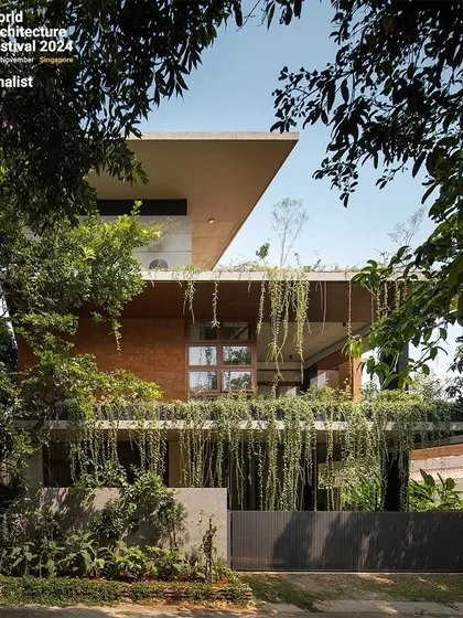 The exterior of the 'House of Greens' showcases my passion for biophilic architecture. Cascading greenery drapes over the concrete facade, creating a living skin that cools the home and blurs the boundary between the building and the landscape. This approach turns a simple residence into a natural sanctuary within the city.