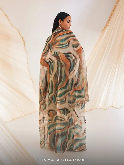 The back view of our Vivien cape set, showcasing the full expanse of the silky organza cape with its beautiful, abstract print.