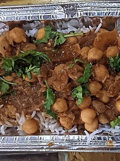 A close-up of my Chole and Rice combo. The chickpeas are cooked in a thick, spicy gravy that is full of flavor.